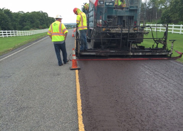 Applying micro surfacing treatment to roadway in Oklahoma